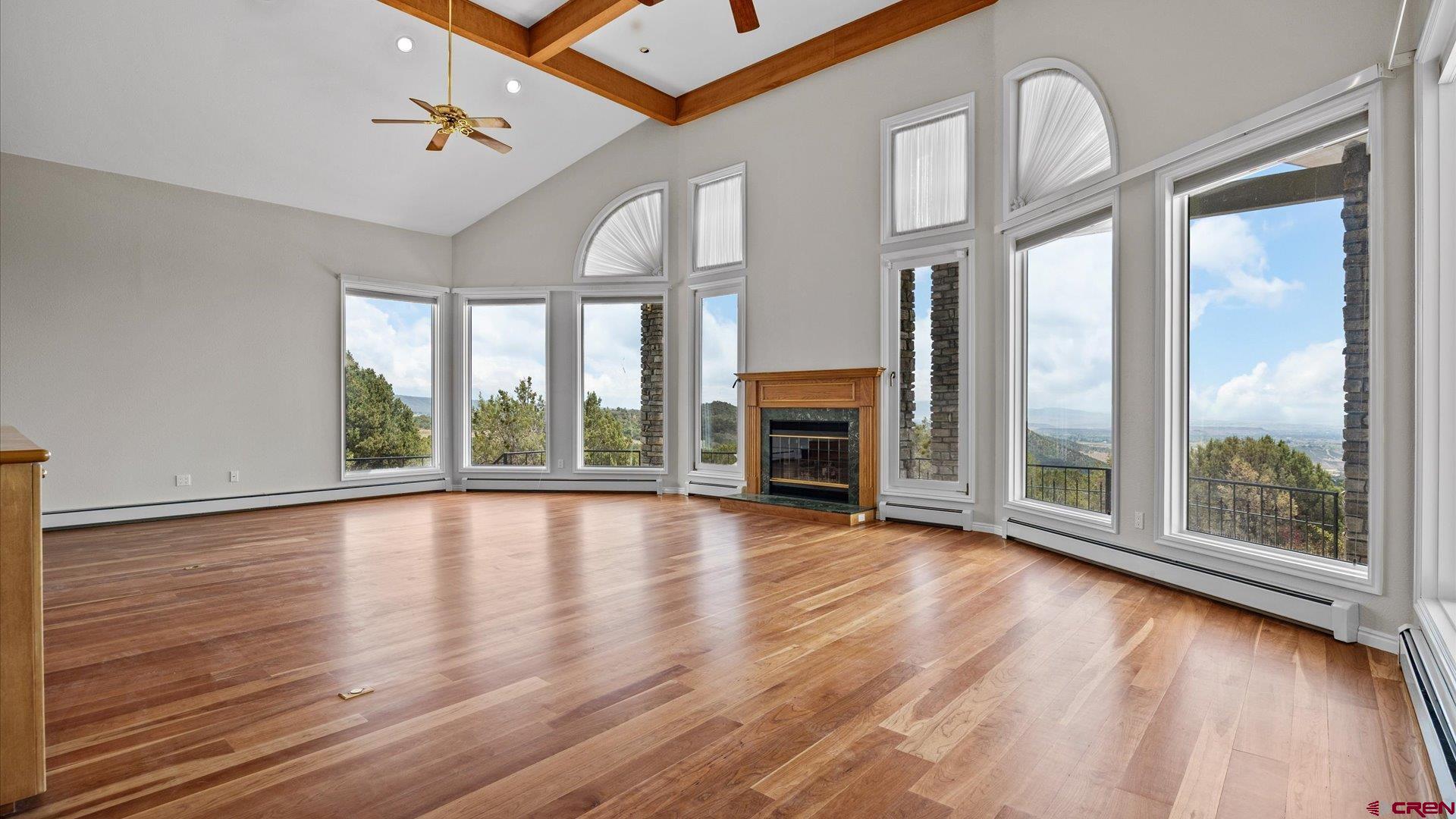 20508 Green Valley Road Cedaredge, CO 81413 - Photo 12 of 42 a view of an empty room with wooden floor and a window