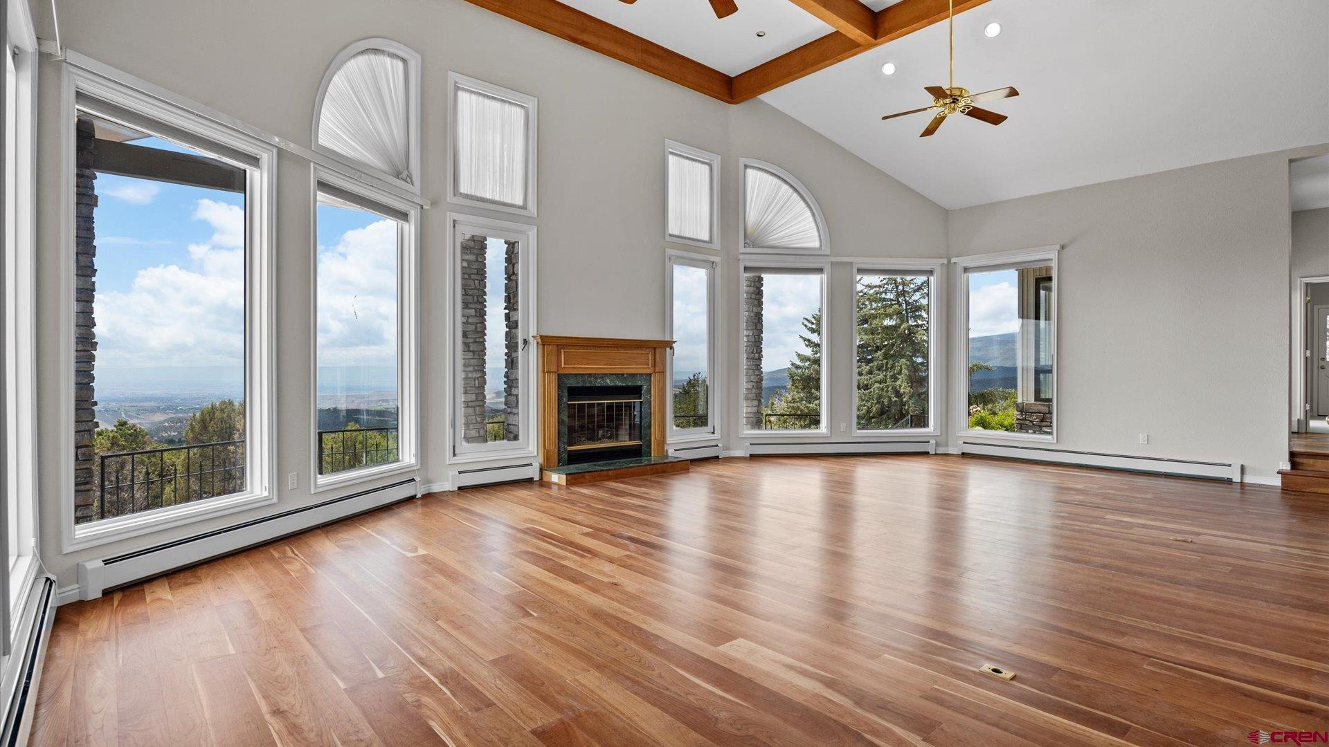 20508 Green Valley Road Cedaredge, CO 81413 - Photo 13 of 42 a view of an empty room with wooden floor and a window