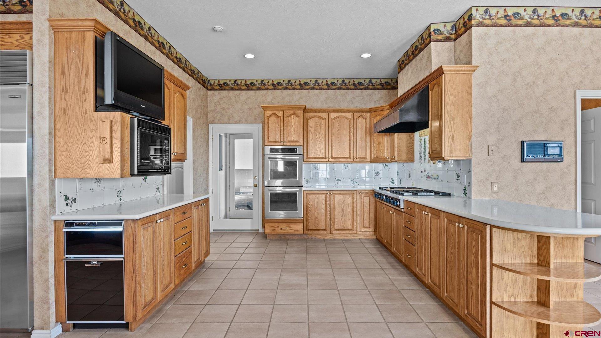 20508 Green Valley Road Cedaredge, CO 81413 - Photo 18 of 42 a large kitchen with stainless steel appliances granite countertop a large counter top a stove and a refrigerator