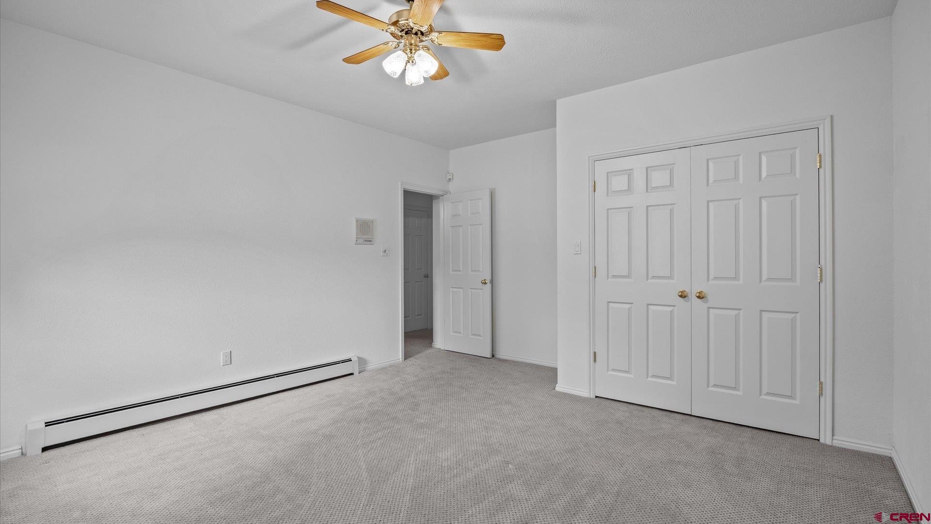 20508 Green Valley Road Cedaredge, CO 81413 - Photo 30 of 42 an empty room with a chandelier fan
