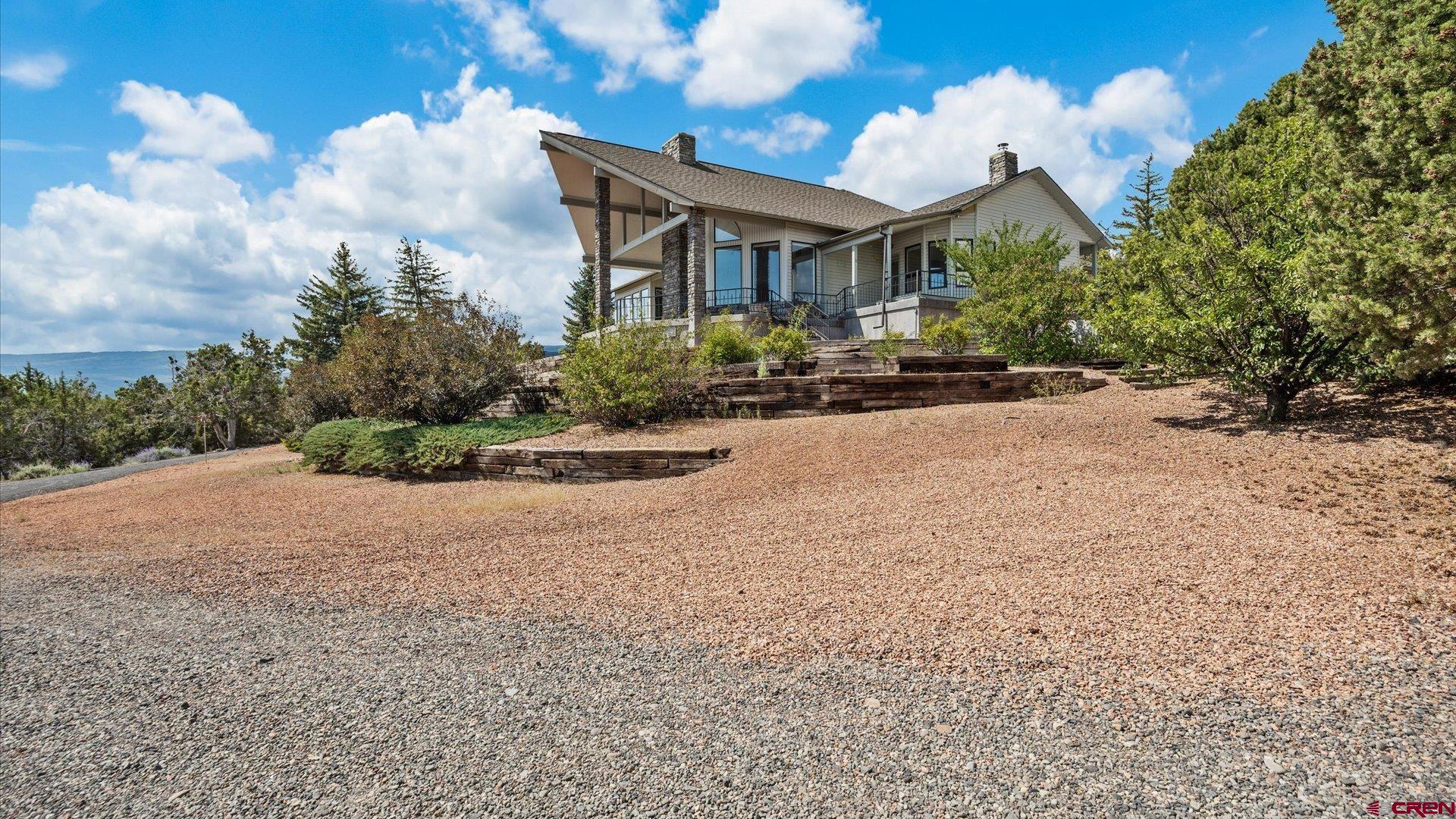 20508 Green Valley Road Cedaredge, CO 81413 - Photo 3 of 42 a view of a house with a yard