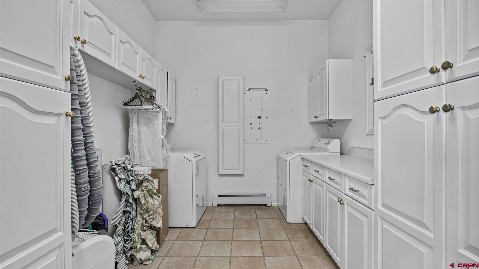 20508 Green Valley Road Cedaredge, CO 81413 - Photo 36 of 42 a kitchen with a refrigerator and white cabinets