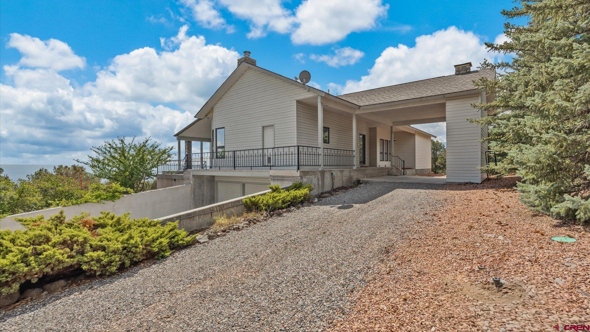20508 Green Valley Road Cedaredge, CO 81413 - Photo 37 of 42 a front view of a house with garden