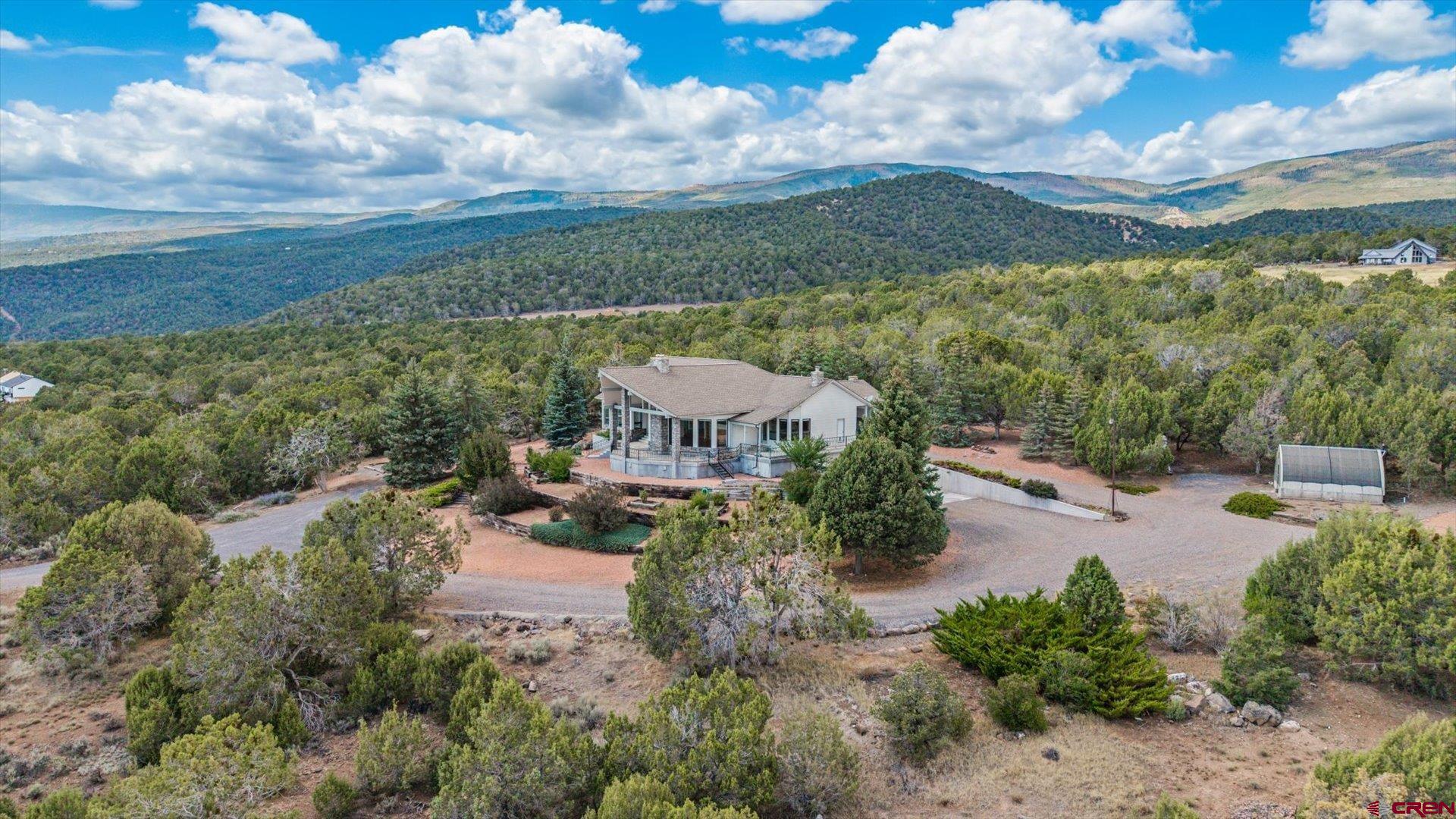 20508 Green Valley Road Cedaredge, CO 81413 - Photo 4 of 42 an aerial view of a house with garden space and street view