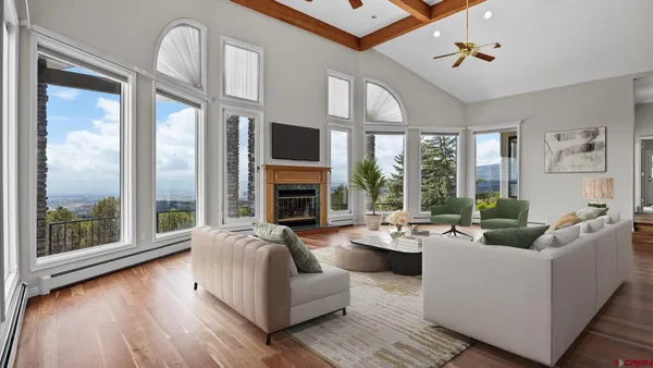 a view of empty room with wooden floor and fireplace