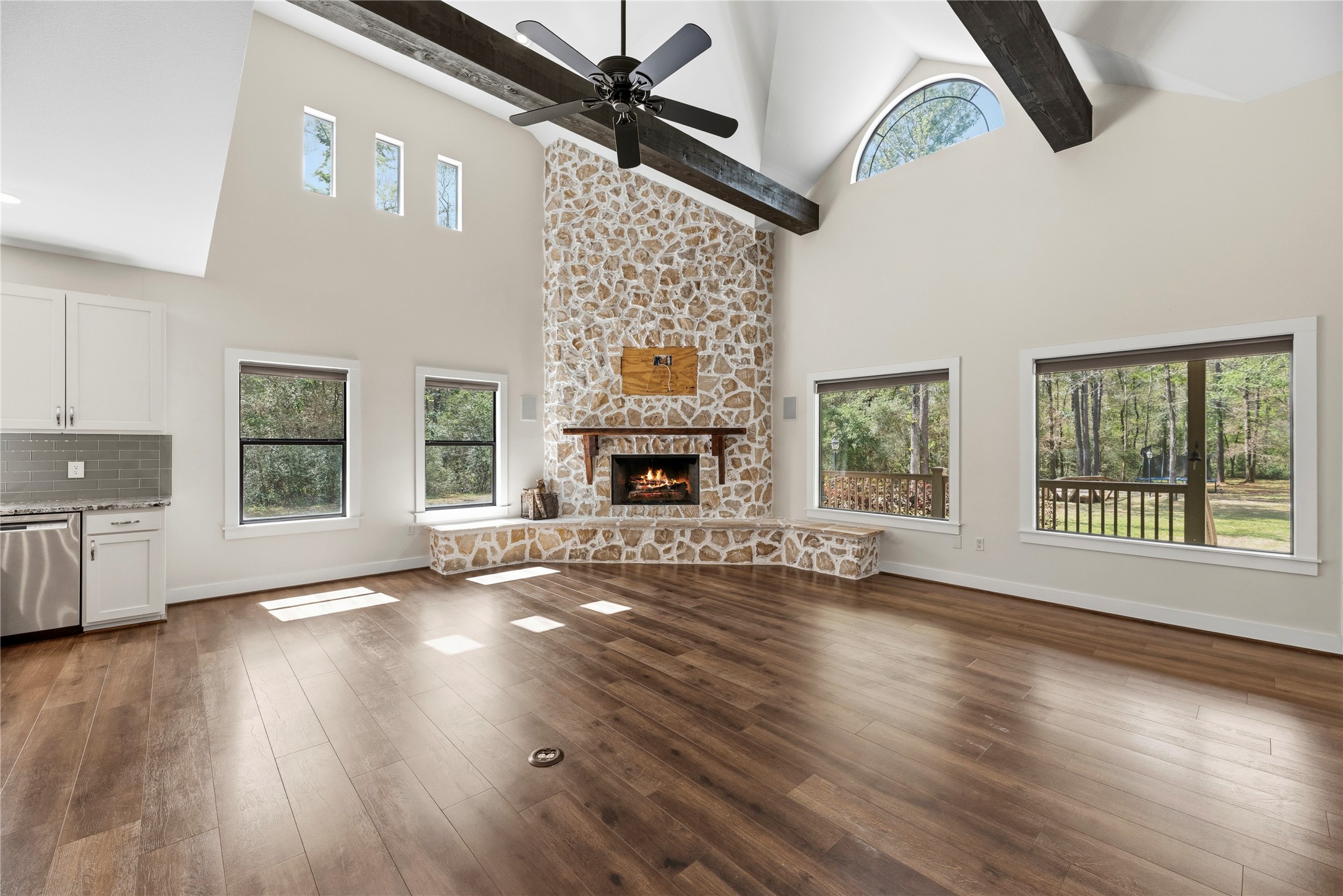12062 Ike White Road Conroe, TX 77303 - Photo 12 of 37 High ceiling with wood beams and natural light create a warm living space.