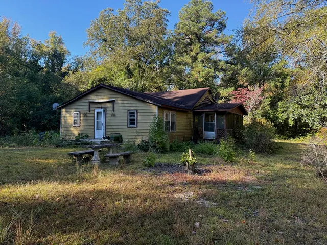 a view of house with outdoor seating