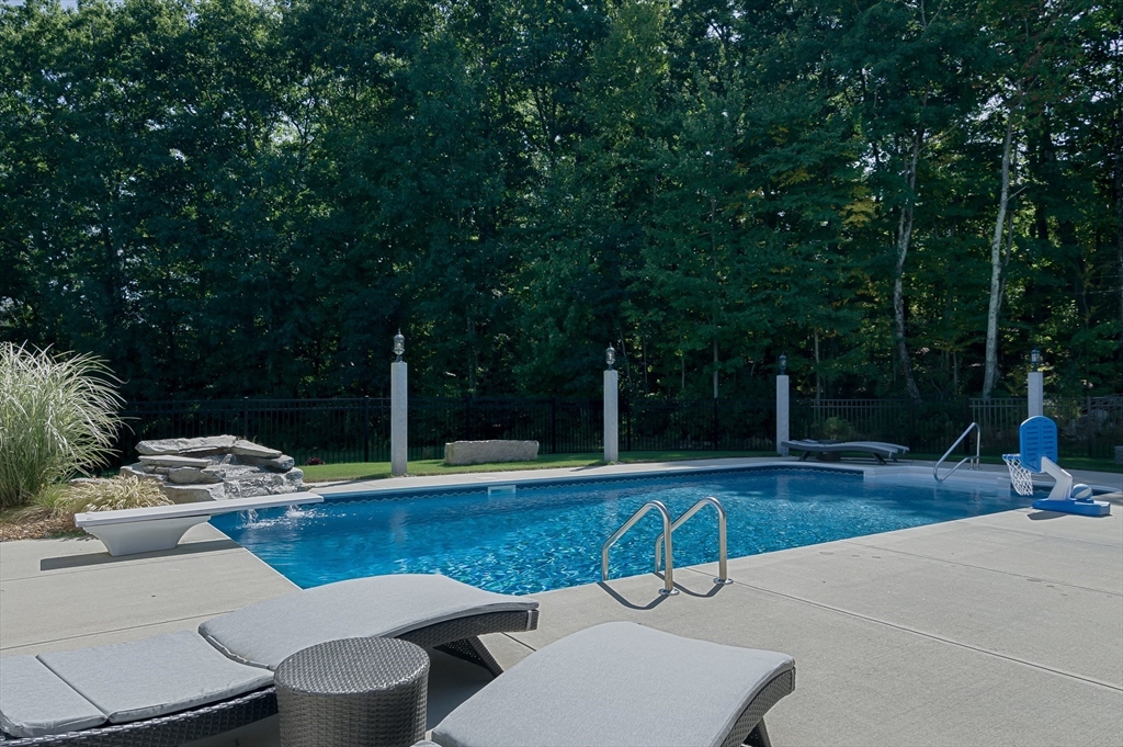 6 Carlson's Way Rutland, MA 01543 - Photo 29 of 34 a view of a swimming pool with lawn chairs under an umbrella