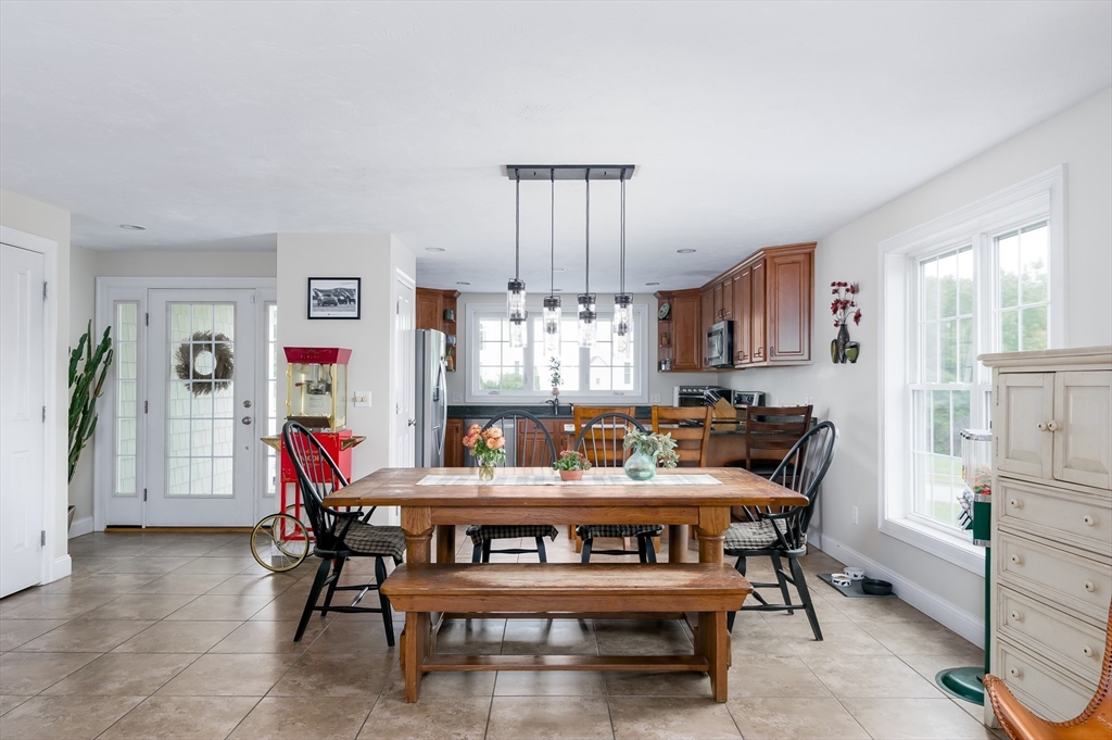 6 Carlson's Way Rutland, MA 01543 - Photo 3 of 34 a table room with a dining table wooden floor and a chandelier