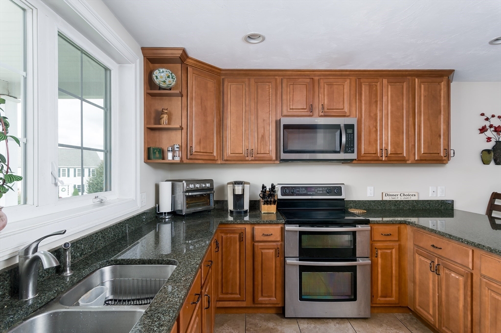 6 Carlson's Way Rutland, MA 01543 - Photo 7 of 34 a kitchen with stainless steel appliances granite countertop a stove a sink and a microwave