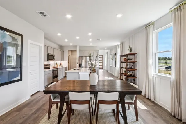 a view of a dining room with furniture and wooden floor