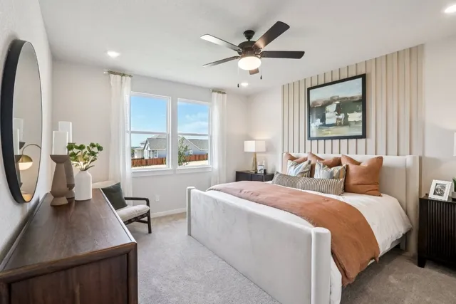 a bed room with a bed window and a mirror