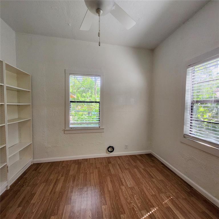 809 Northwest 4th Avenue Gainesville, FL 32601 - Photo 8 of 15 an empty room with wooden floor and windows