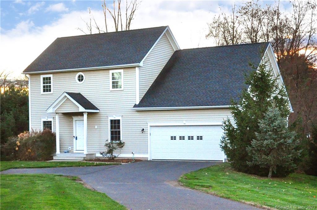5 Chapman Chase, Unit 5 Windsor Locks, CT 06096 - Photo 1 of 1 a front view of a house with a garden and plants