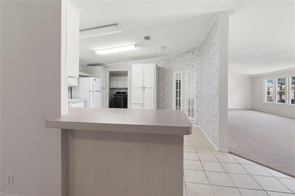 8307 Nancy Lane Ellenton, FL 34222 - Photo 14 of 57 a kitchen with stainless steel appliances a refrigerator and cabinets