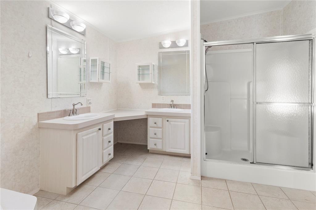 8307 Nancy Lane Ellenton, FL 34222 - Photo 30 of 57 a spacious bathroom with a shower sink and a mirror