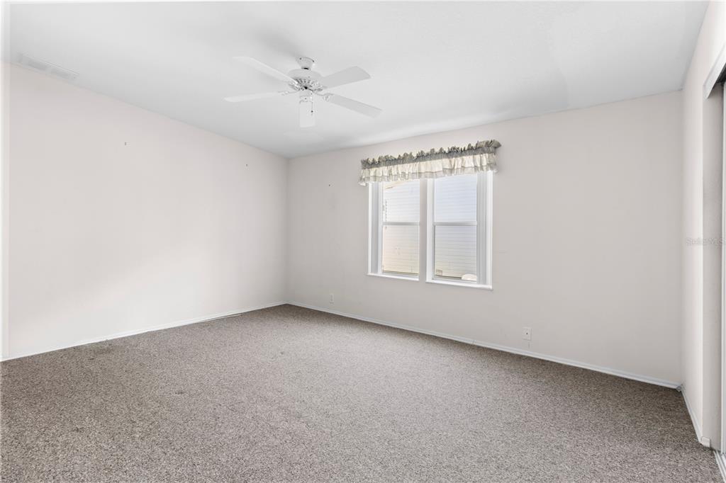 8307 Nancy Lane Ellenton, FL 34222 - Photo 32 of 57 an empty room with windows and fan