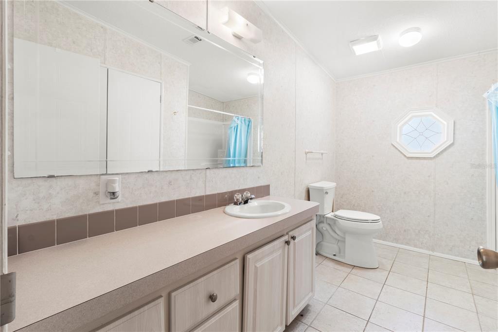 8307 Nancy Lane Ellenton, FL 34222 - Photo 34 of 57 a bathroom with a sink a toilet and mirror