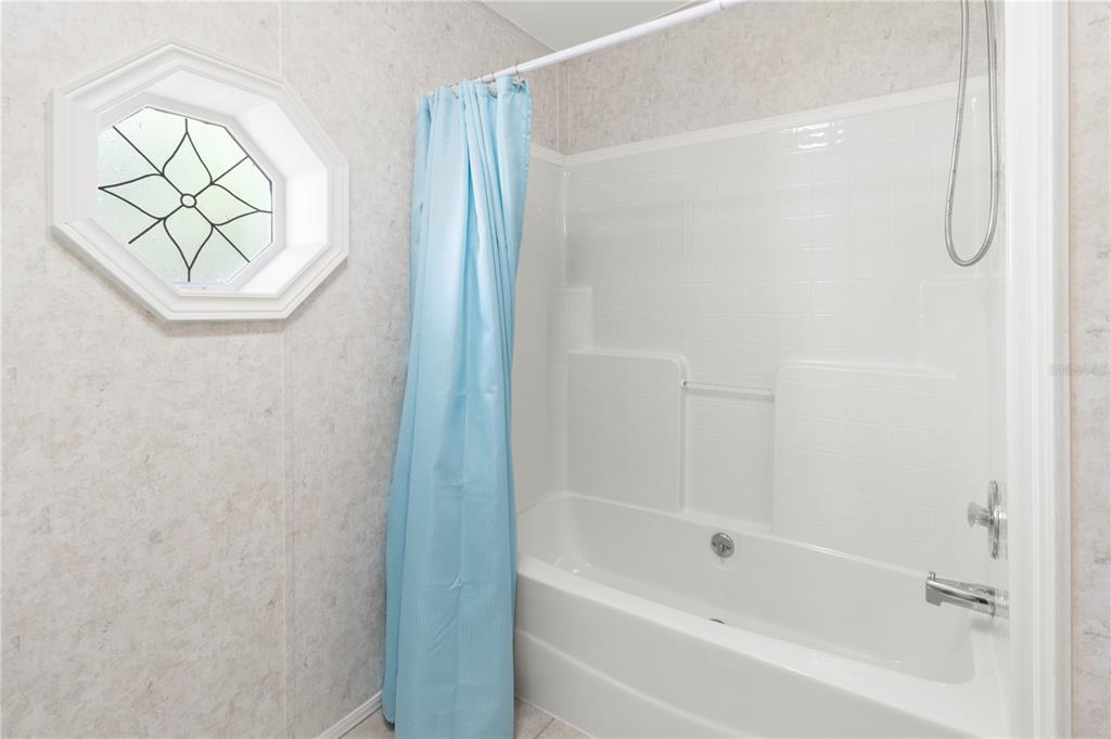 8307 Nancy Lane Ellenton, FL 34222 - Photo 35 of 57 a bathroom with a bathtub and a shower