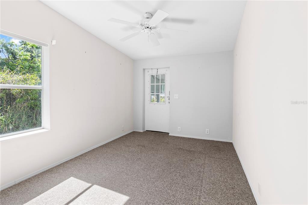 8307 Nancy Lane Ellenton, FL 34222 - Photo 37 of 57 an empty room with windows and ceiling fan