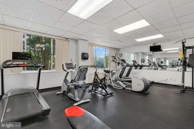 a room with gym equipment and a large mirror