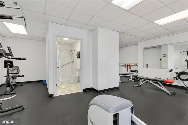 a room with gym equipment and a mirror
