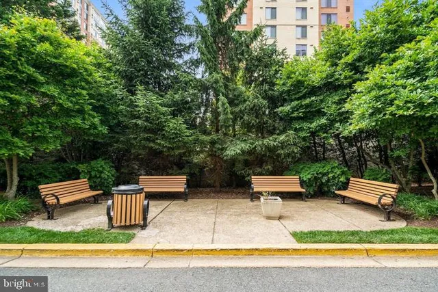 a view of a tall building next to a road