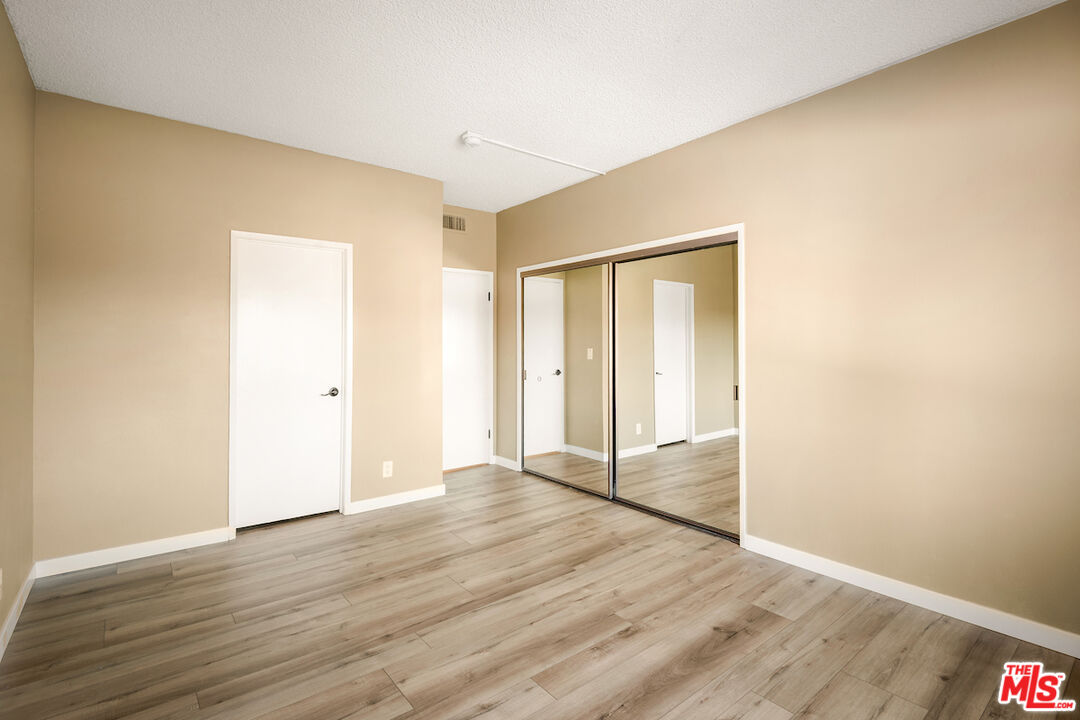 1944 Glendon Avenue, Unit 309 Los Angeles, CA 90025 - Photo 14 of 30 a view of an empty room with wooden floor