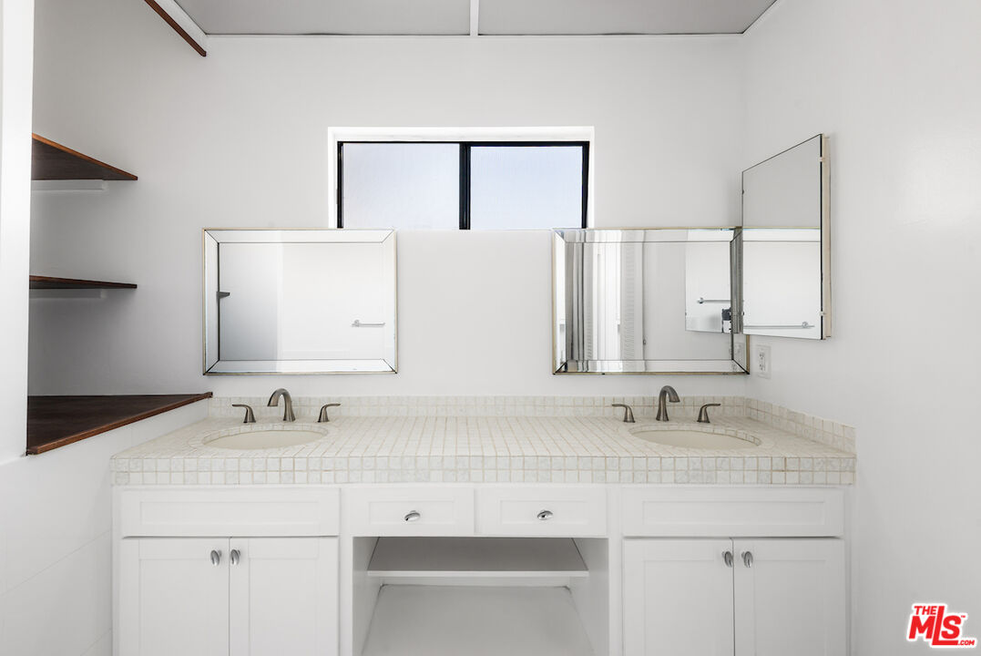 1944 Glendon Avenue, Unit 309 Los Angeles, CA 90025 - Photo 16 of 30 a bathroom with a sink and a mirror