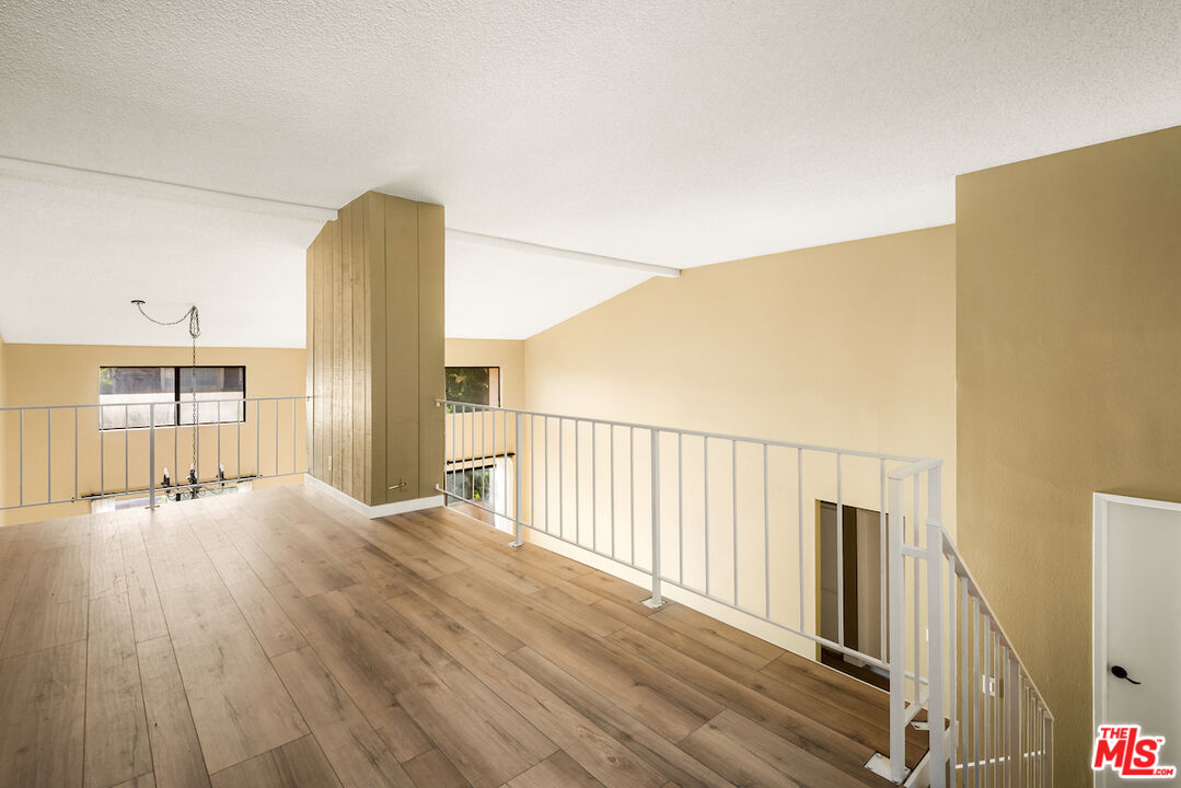 1944 Glendon Avenue, Unit 309 Los Angeles, CA 90025 - Photo 22 of 30 a view of an empty room with wooden floor
