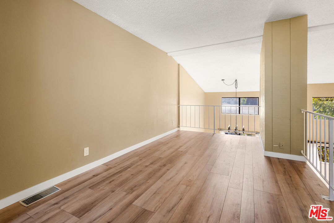 1944 Glendon Avenue, Unit 309 Los Angeles, CA 90025 - Photo 23 of 30 a view of a room with wooden floor