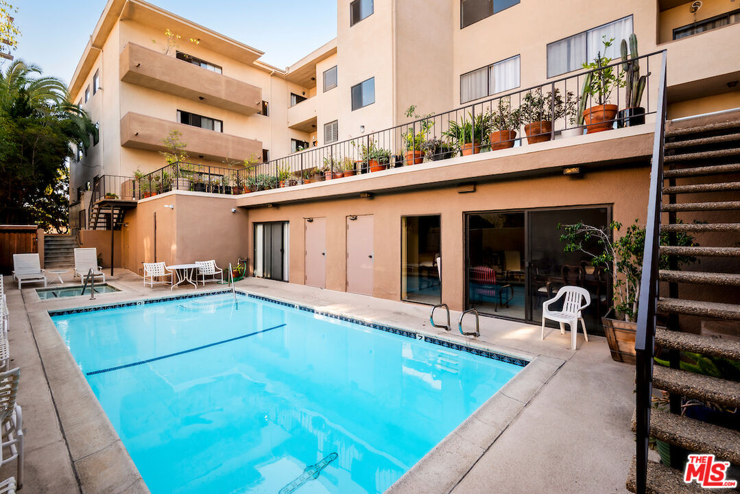 1944 Glendon Avenue, Unit 309 Los Angeles, CA 90025 - Photo 28 of 30 a view of a patio with a table and chairs and potted plants