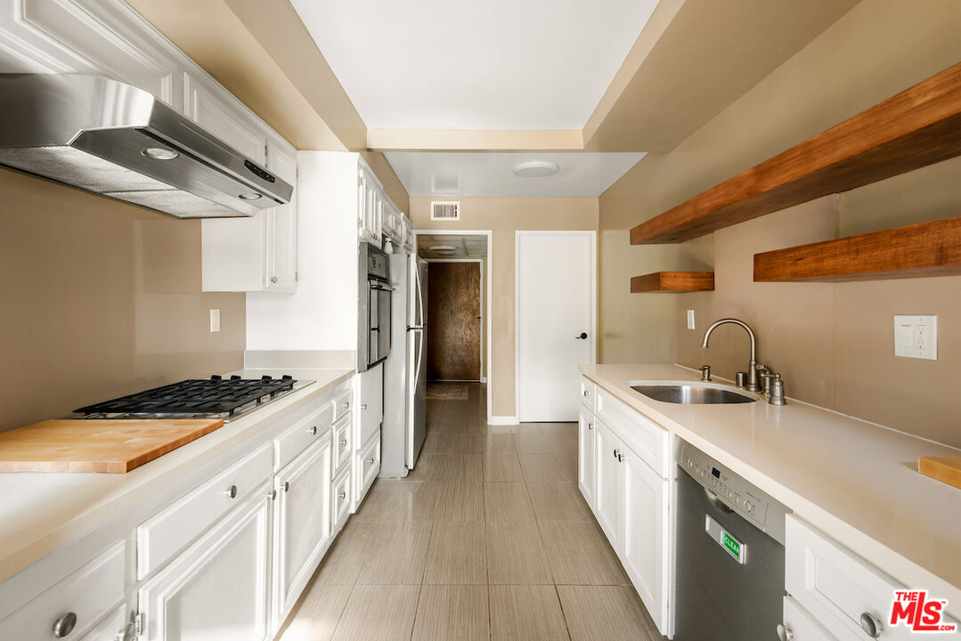 1944 Glendon Avenue, Unit 309 Los Angeles, CA 90025 - Photo 7 of 30 a kitchen with stainless steel appliances granite countertop a sink and stove