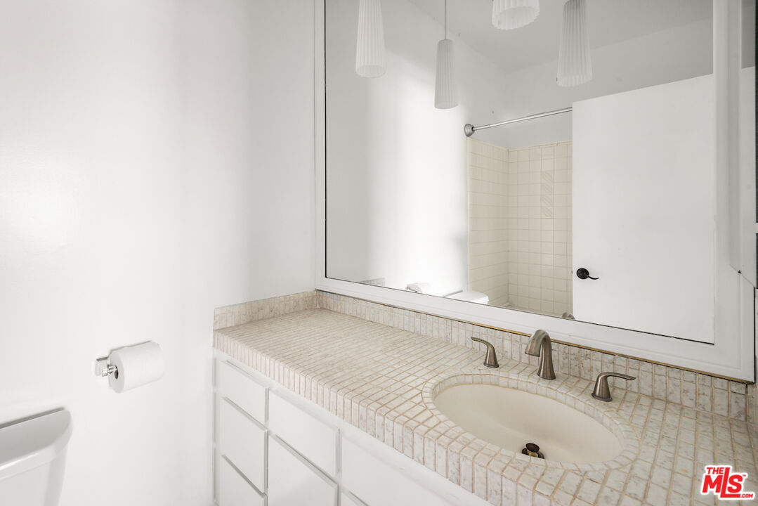 1944 Glendon Avenue, Unit 309 Los Angeles, CA 90025 - Photo 10 of 30 a bathroom with a sink and a mirror