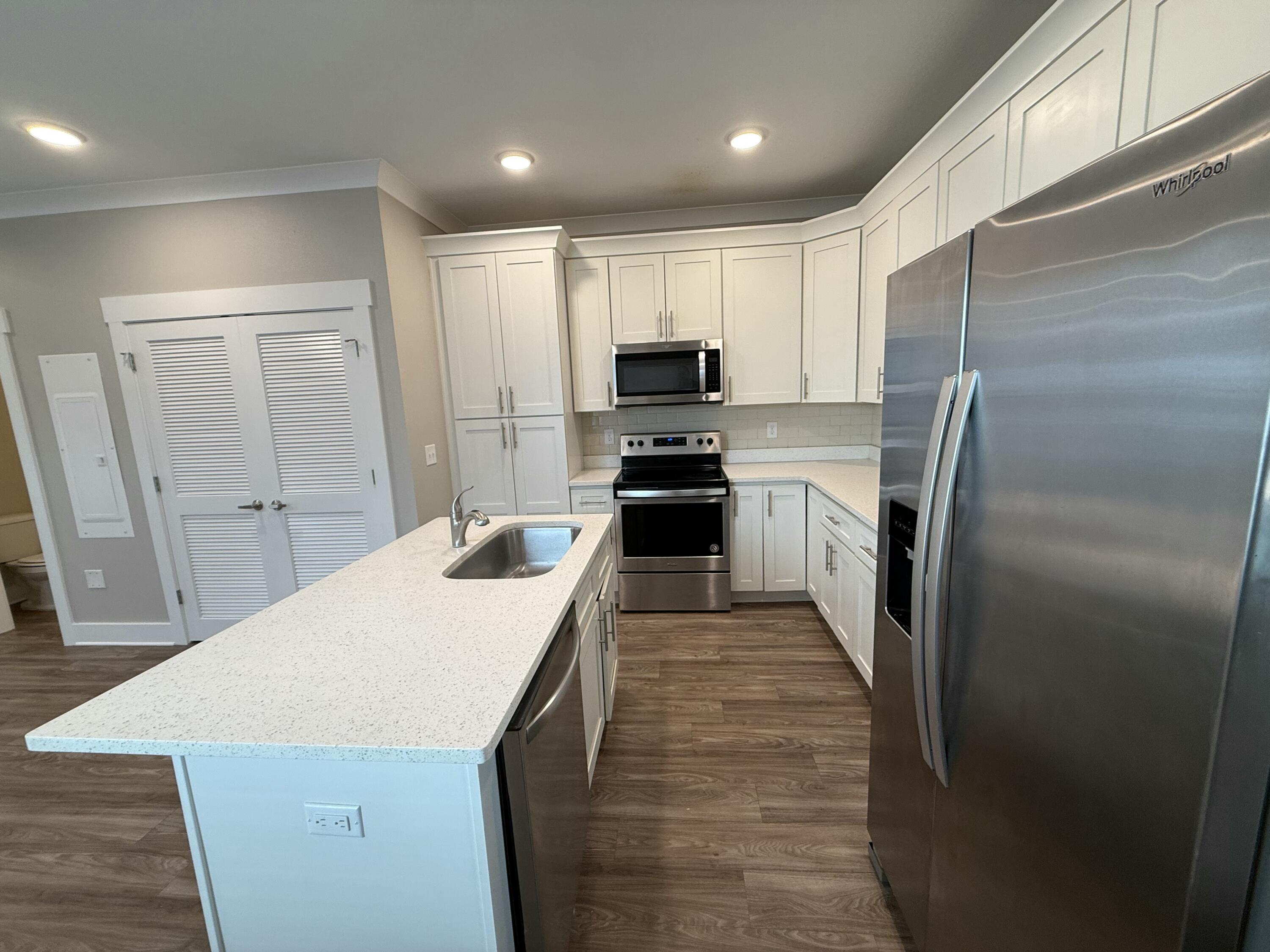 142 North Sand Palm Road Freeport, FL 32439 - Photo 13 of 26 a kitchen with kitchen island a refrigerator sink and stove