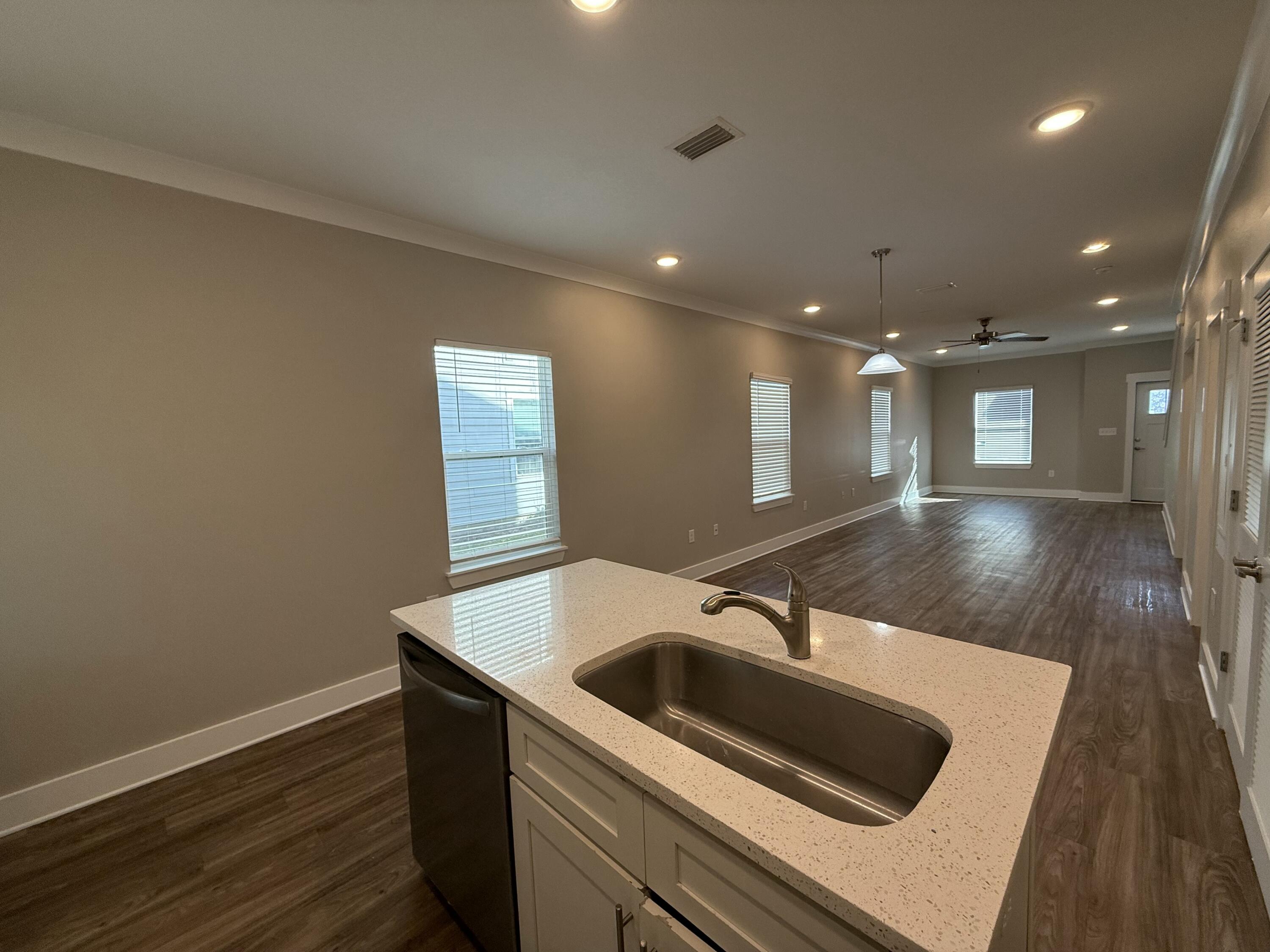 142 North Sand Palm Road Freeport, FL 32439 - Photo 14 of 26 a kitchen with a sink and a refrigerator