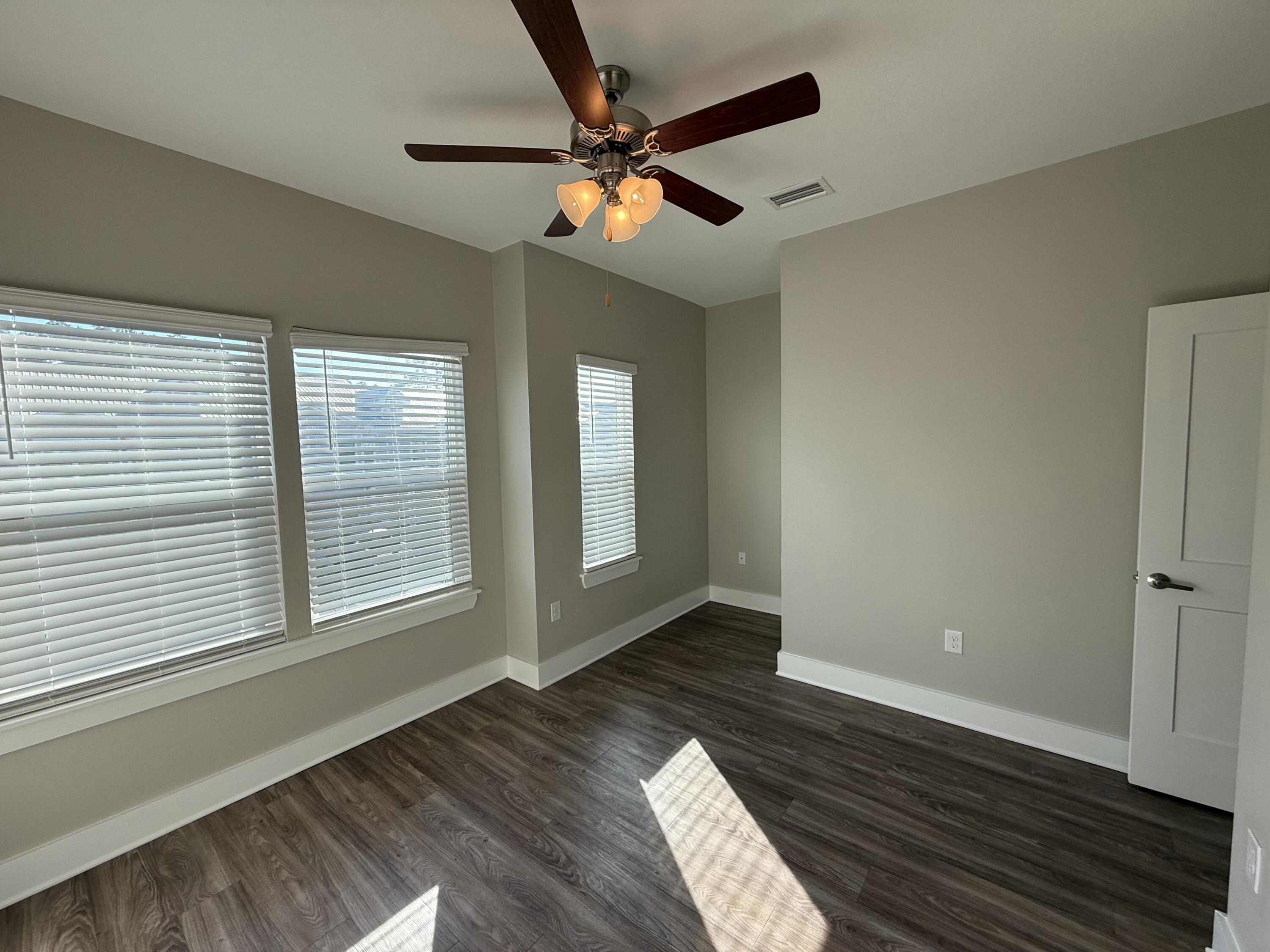 142 North Sand Palm Road Freeport, FL 32439 - Photo 17 of 26 a view of an empty room with wooden floor and a window