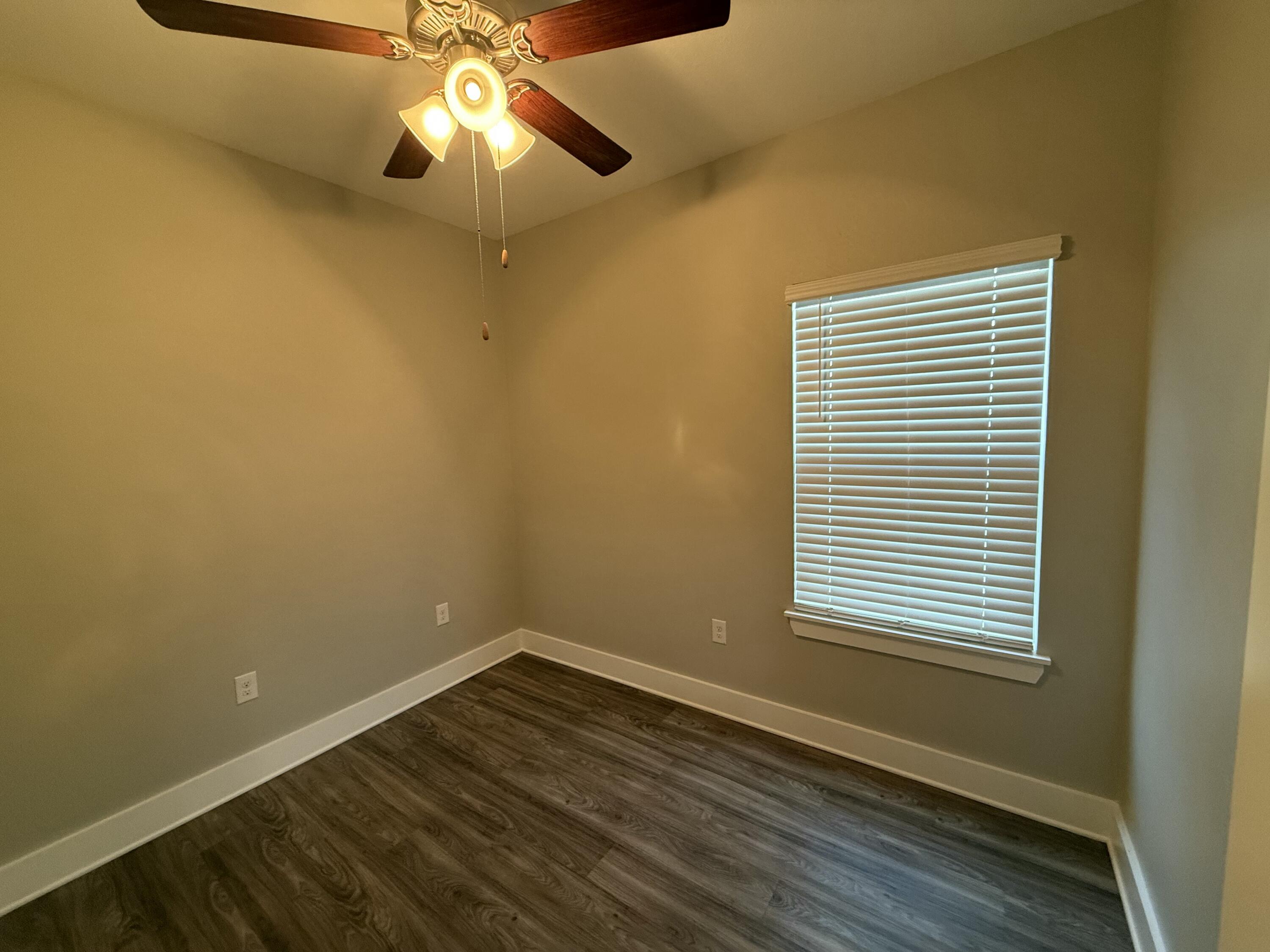 142 North Sand Palm Road Freeport, FL 32439 - Photo 19 of 26 a view of empty room with wooden floor and fan