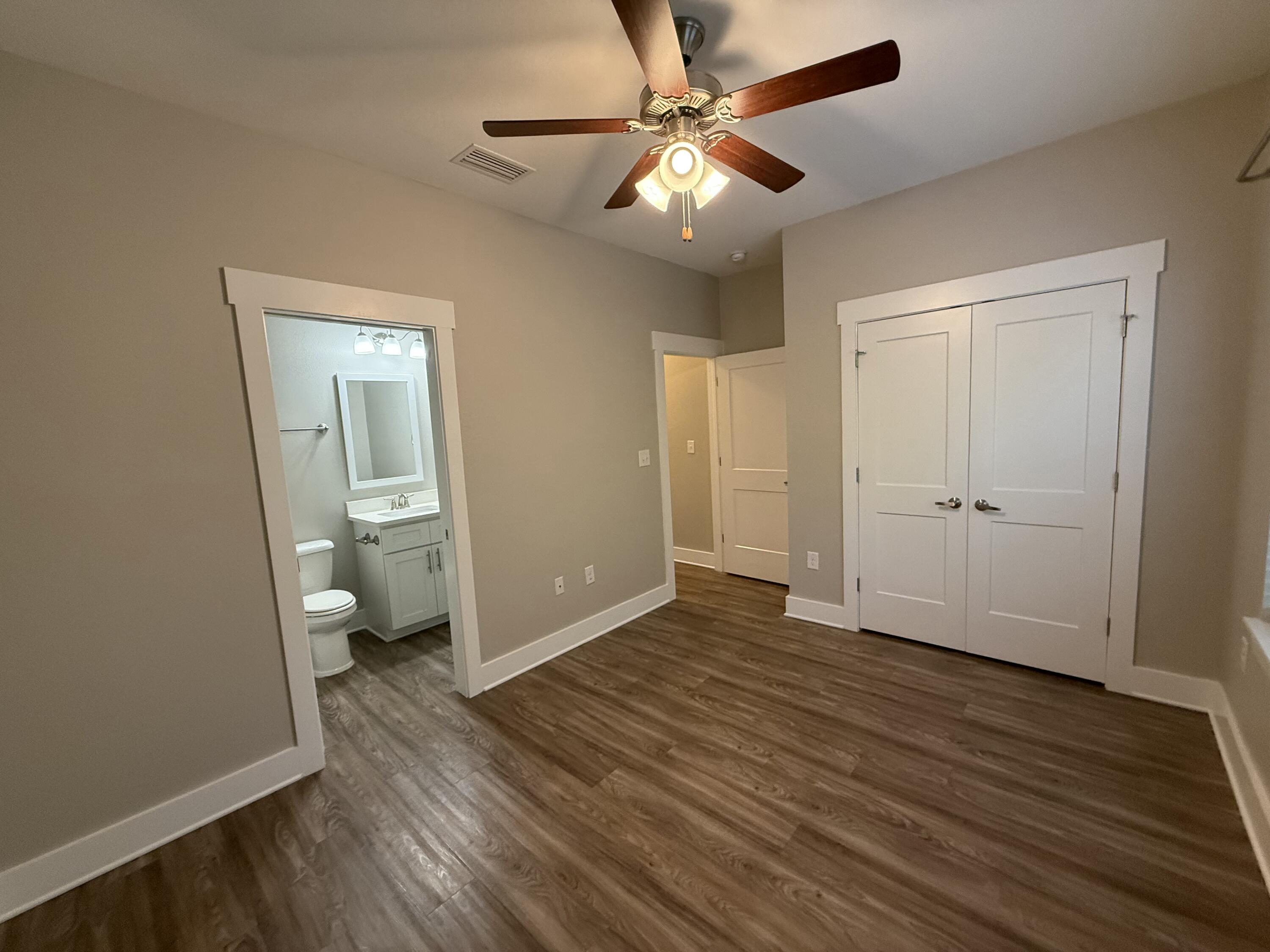 142 North Sand Palm Road Freeport, FL 32439 - Photo 26 of 26 a view of a room with wooden floor and a ceiling fan
