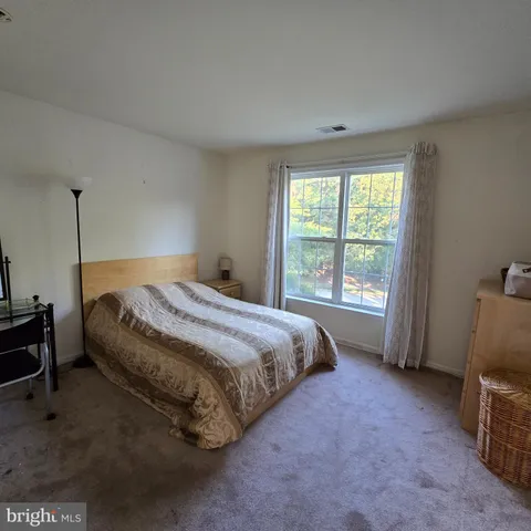 a bed sitting in a room next to a window