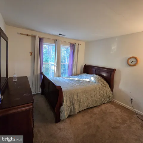 a bedroom with a bed and a television