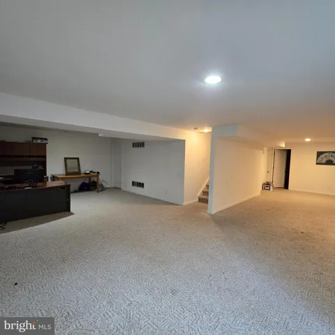 a view of a big room with closet and windows