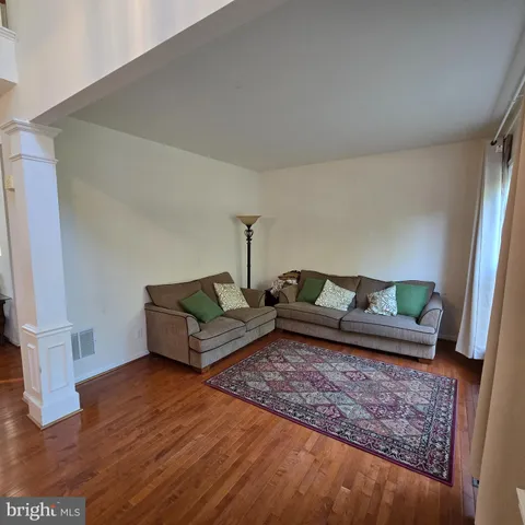 a living room with furniture and a rug