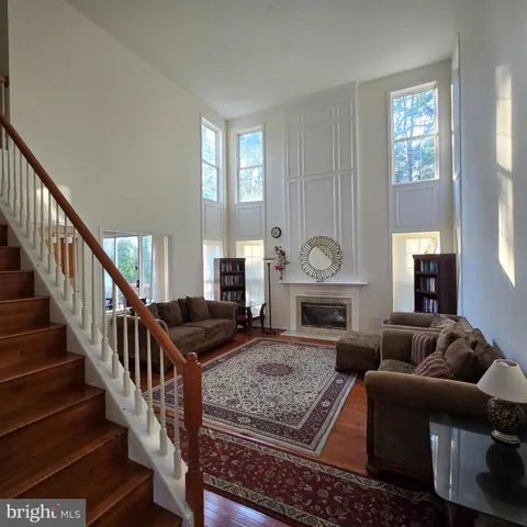 a living room with furniture fireplace and a window