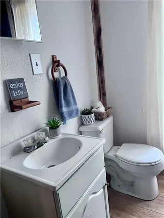 a bathroom with a toilet sink and mirror