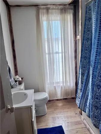a bathroom with a sink toilet and window