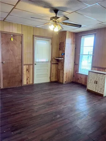a view of a room with wooden floor and furniture