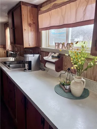 a kitchen with a sink and a large window