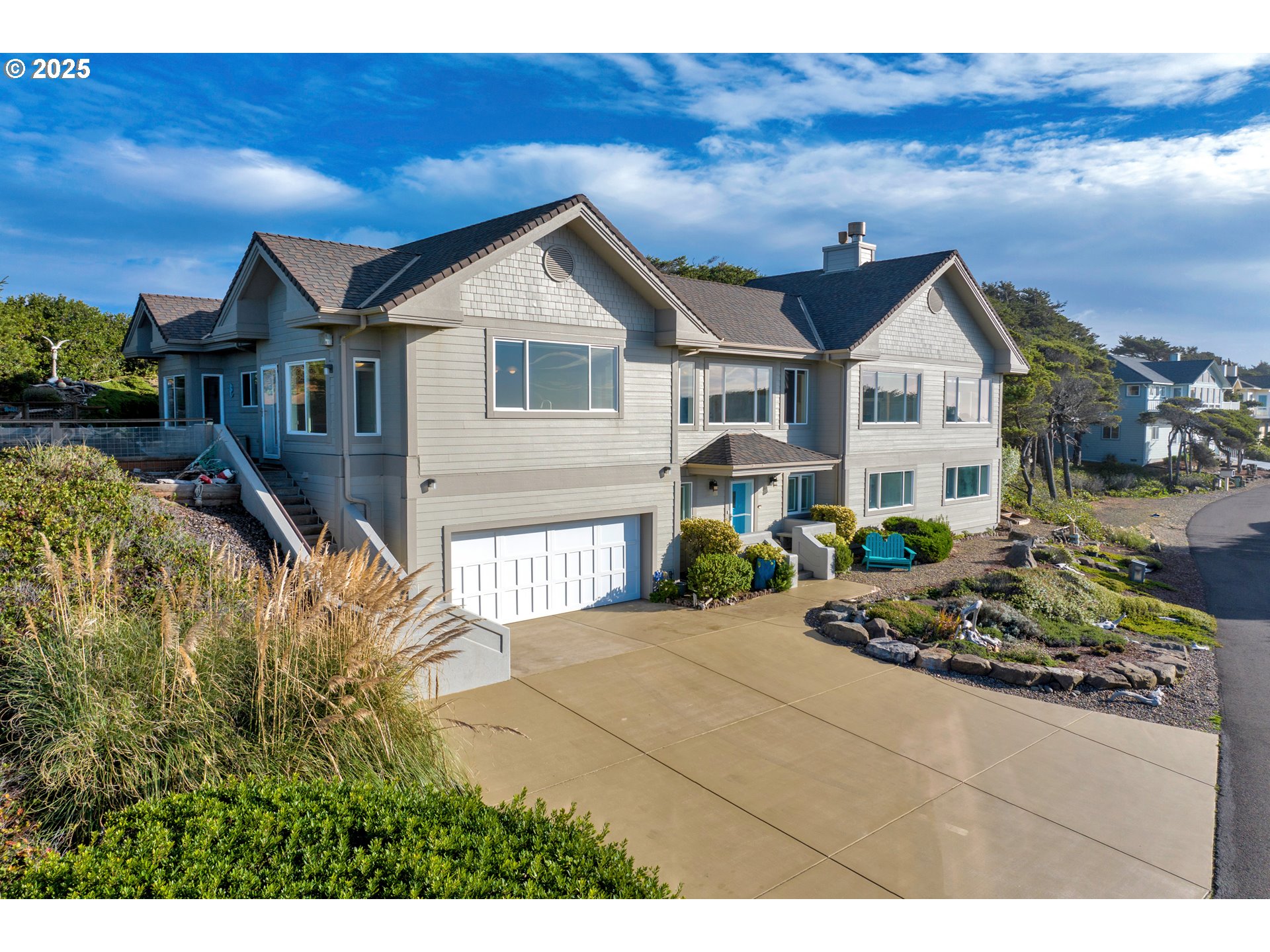 88765 Shoreline Loop Florence, OR 97439 - Photo 1 of 48 a front view of a house with a garden