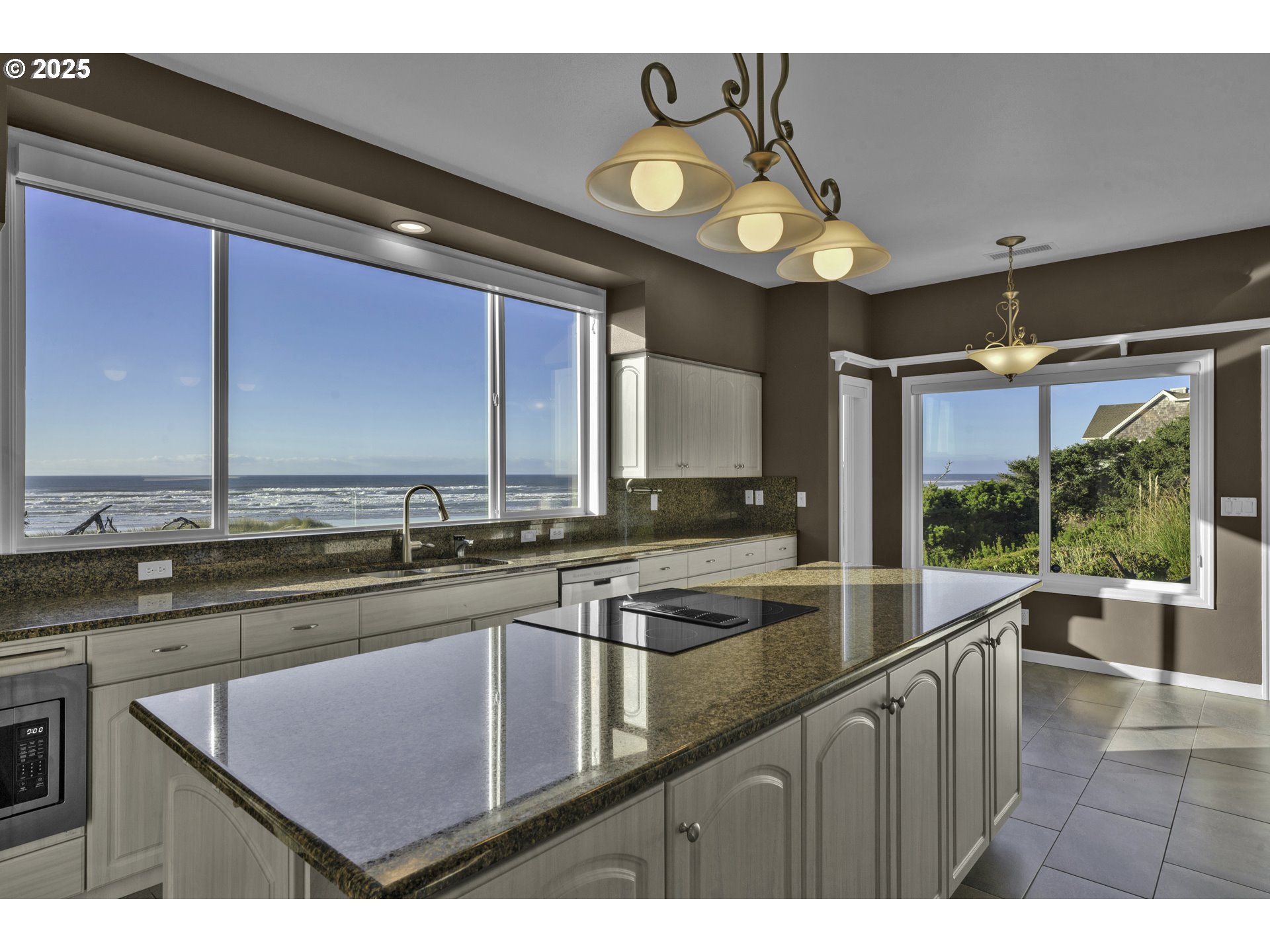 88765 Shoreline Loop Florence, OR 97439 - Photo 13 of 48 a kitchen with a sink a counter top space cabinets and stainless steel appliances